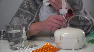 Man does inhalation at home during an illness pneumonia, infection with coronavirus covid 19. Medical inhaler, nebulizer, nebular. Asthma breathing treatment. Bronchitis, asthmatic health equipment
