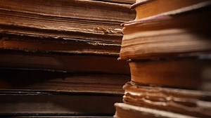 Macro view of saved medieval books with ancient writings. Religious literature, archival manuscripts, rare collection tomes, artifacts.