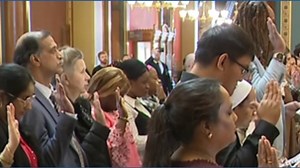 Newly naturalized American citizens take oath of allegiance at the Iowa State Capitol