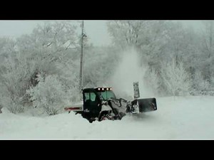 TOOLCAT 5600 SNOW BLOWING A PILE OF SNOW