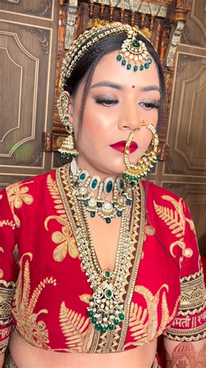 Skylark salon & boutique on Instagram: "vision in legacy red • timeless soft-glam layered with heirloom jewels, a glow that feels royal yet rooted, and the kind of poise only a @sabyasachiofficial bride carries ✨. #makeup #wedding #skylarksalon #hairdo #bride"