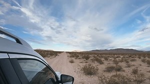 clip-1108497613-side-view-car-driving-offroad-through-nevada