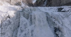 Afternoon winter aerial video of frozen Ithaca Falls on Fall Creek, City of Ithaca, NY, USA 01-21-2024