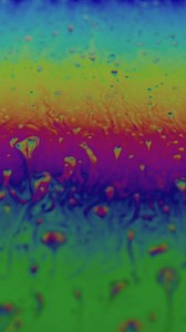 Shapes and iridescent colors of a soap bubble - Free Stock Video