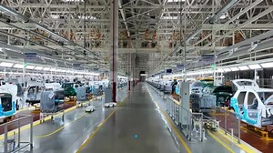 Robot arm inspecting an automobile assembly line works in a factory used in cars or electric vehicle