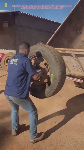 The process of loading a large wheel into the back of a truck