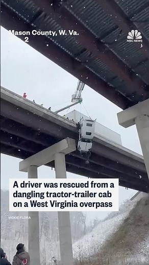 A driver was rescued from dangling tractor-trailer cab on a West Virginia overpass
