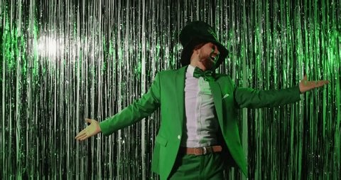 clip-3760900357-funny-man-dressed-green-suit-dancing-against
