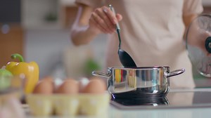 Free stock video - Woman cooking soup in the kitchen