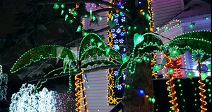 Tropical themed Christmas decorations and lights on a house decorated for Christmas Stock Video