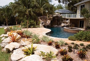 Custom Swimming Pool with Natural Stone Waterfalls and Pool Grotto