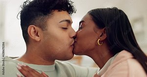 Couple on couch, kiss in living room of home and excited in marriage, relationship and future. Romance, affection and embrace, man and woman on sofa with smile, love and happiness in house together.