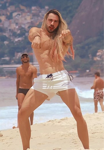 Muscular Man Dancing on Scenic Beach