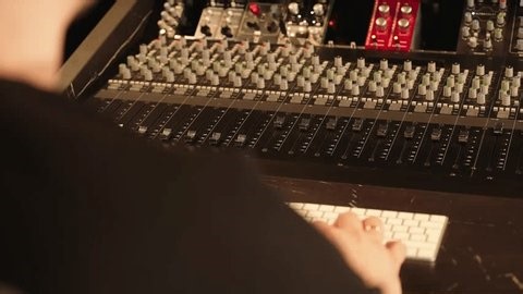 clip-4016299549-sound-engineer-works-mixer-hands-operate-computer