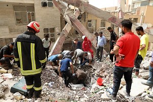 Iran mourns building collapse victims as toll tops 30