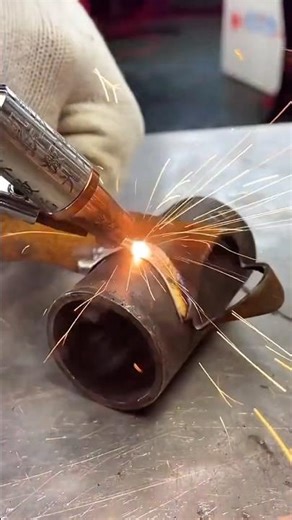 Welder Joining Two Metal Rings Using an Oxy-Fuel Torch