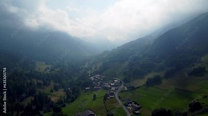 Mist covers the Cottian Alps and the municipality near Busca below. Italy