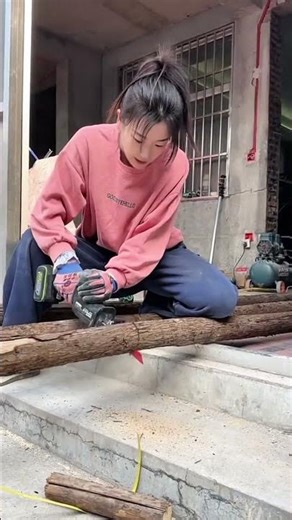 Cutting wooden logs using portable electric reciprocating saw for outdoor building project activity