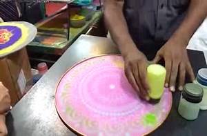 Making complex sand art with a stencil.