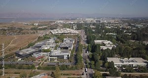 Aerial of new Google plex HQ with solar panels and tensile structure on the roof in mountain view california fly forward