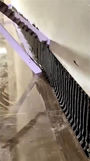 Applying adhesive on the wall to install baseboard and decorative tiles for renovation