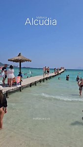 The beach of Alcudia on a summer’s day feels like paradise come to life. The soft, white sand warms your feet as the gentle waves kiss the shore. Families laugh and splash in the crystal-clear water, which sparkles under the sun and offers the perfect temperature for a refreshing swim. Children build sandcastles, couples stroll hand in hand, and the scent of sunscreen lingers in the salty breeze. The sky is a flawless blue, and the sea stretches endlessly, blending into the horizon. Time slows d