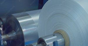 roll of cellophane from the conveyor in production of PVC polymers.