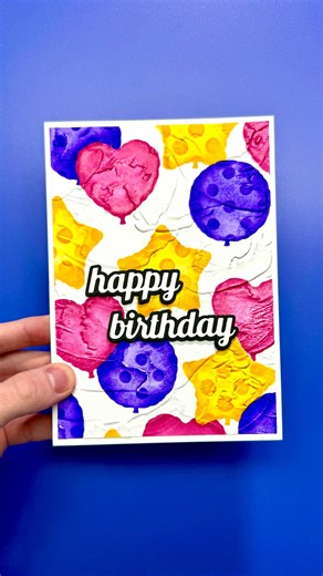 Simon Hurley on Instagram: "This Plaster Embossing Folder takes an easy DIY birthday card to the NEXT LEVEL!😮‍💨 Leave a comment with the word “balloon” and I’ll share the supplies list with you to create this card. I started off by adding texture to my cardstock using the Plaster 3D Embossing Folder. I am obsessed with the insane detail in this folder… it looks like frosting!😋 Then, I ink blended several layers of balloons using the Party Balloons stencil set with Simon H