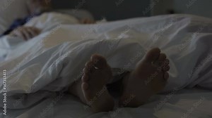 Sleeping man scratching his feet, nasty smell and discomfort due to foot fungus