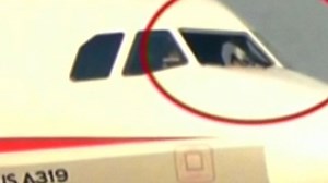 Co-pilot sucked halfway out broken windshield