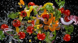 clip-1041679894-fresh-vegetables-water-droplets-exploding-on-black