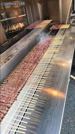 Italian Food. Cooking and Roasting the Small Skewers from Abruzzo. Arrosticini