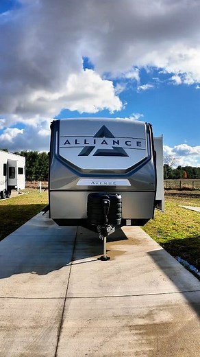 Meet the Avenue 332RL Travel Trailer by Alliance RV. Why you'll love it: ✅ Spacious rear living with dual recliner theater seating, a rear sleeper sofa, and hidden storage behind a 50" swing-mount HDTV. ✅ Floating dinette with a movable ottoman for dining and extra storage. ✅ Kitchen ready with a full-size pantry to keep meal prep simple and organized. ✅ Luxury bedroom featuring a queen bed slide with a king option, washer/dryer prep, and extra storage in a dresser. ✅ Wide-body design with a 101
