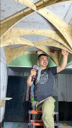 Carpenter Demonstrates The Process Of Installing Curved Ceiling