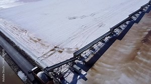 Aerial drone view of Salt production in the evaporators of sea salt in nature reserve Marismas del Odiel. Traditional Sea salt production produced by the evaporation of seawater.
