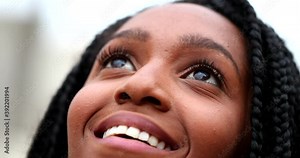 African teen black girl close-up eyes looking up to sky with HOPE and FAITH
