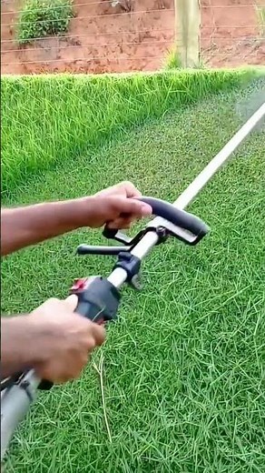 Trimming Long Grass Into A Perfectly Level Lawn Using A Professional Weed Eater