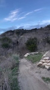 This guy riding a mountain bike on a dirt trail failed miserably. He was supposed to slow down before a jump, but he didn't. As a result, he immediately had to bail out and jump off his bike in mid-air to avoid an accident. | Jukin Copyright Management