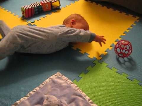 Baby reaching for ball