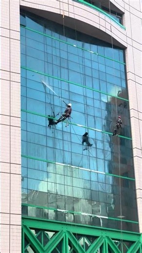 Amazing window cleaning workers on sky scraper