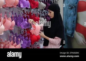 Muslim woman customer, female client in lingerie store chooses pink cute bra for everyday wear. Islamic woman in hijab in lingerie boutique chooses underwear, bras. Choosing and buying clothes in mall Stock Video Footage - Alamy