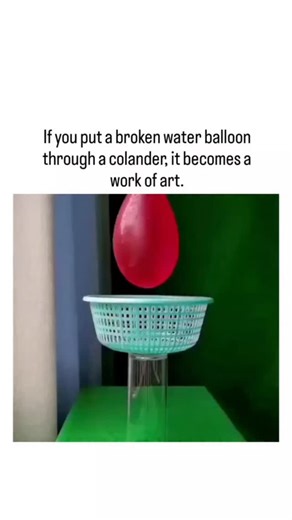 🫠 on Instagram: "The post features a slow-motion video of a red water balloon punctured above a turquoise colander, where water streams through the holes to form delicate, web-like patterns resembling abstract sculptures. Garnering over 23,000 likes and 2 million views within a day, it highlights fluid dynamics principles like surface tension guiding coherent jets, a concept explored in viral experiments since 2020. User replies liken the effect to Dale Chihuly's glass art and propose variation