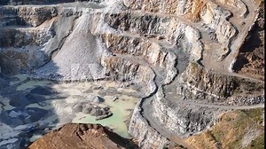 Opencast Mine Aerial View. Industrial terraces in a mining quarry. Open pit mining of dolomite. Excavation machinery of the dolomite mine. Extractive industry. Opencast mining.