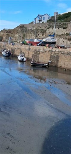 INCOMING TIDE AT PORTREATH HARBOUR IN CORNWALL.