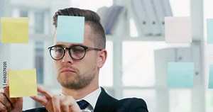 Business man, planning and sticky note on glass board for project timeline, schedule management or brainstorming ideas. Young and professional worker with mission priority, goals and problem solving