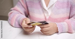 Woman's Hand Holding Debit Card for Secure Online Shopping. E-Business Transaction. Secure Online Purchase. Closeup of Woman Holding Credit Card for Digital Shopping