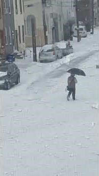 Using an umbrella when it's snowing. ( Philadelphia snow storm of 2026, January 25)