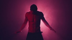 Silhouette of a man rotating his hands in the smoke