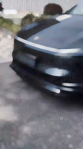 Tesla Model Y 2025 with a sleek black front lip spoiler, enhancing its sporty profile on a scenic road. Close-ups show textured carbon fiber finish and installation hardware. #TeslaMods #ModelYJuniper #CarUpgrades #Yeslak #LuxuryOnABudget | Yeslak Accessories for Tesla