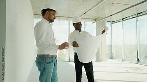 Indian and African architects discussing about the building plan and see how the construction progressive at the construction site
